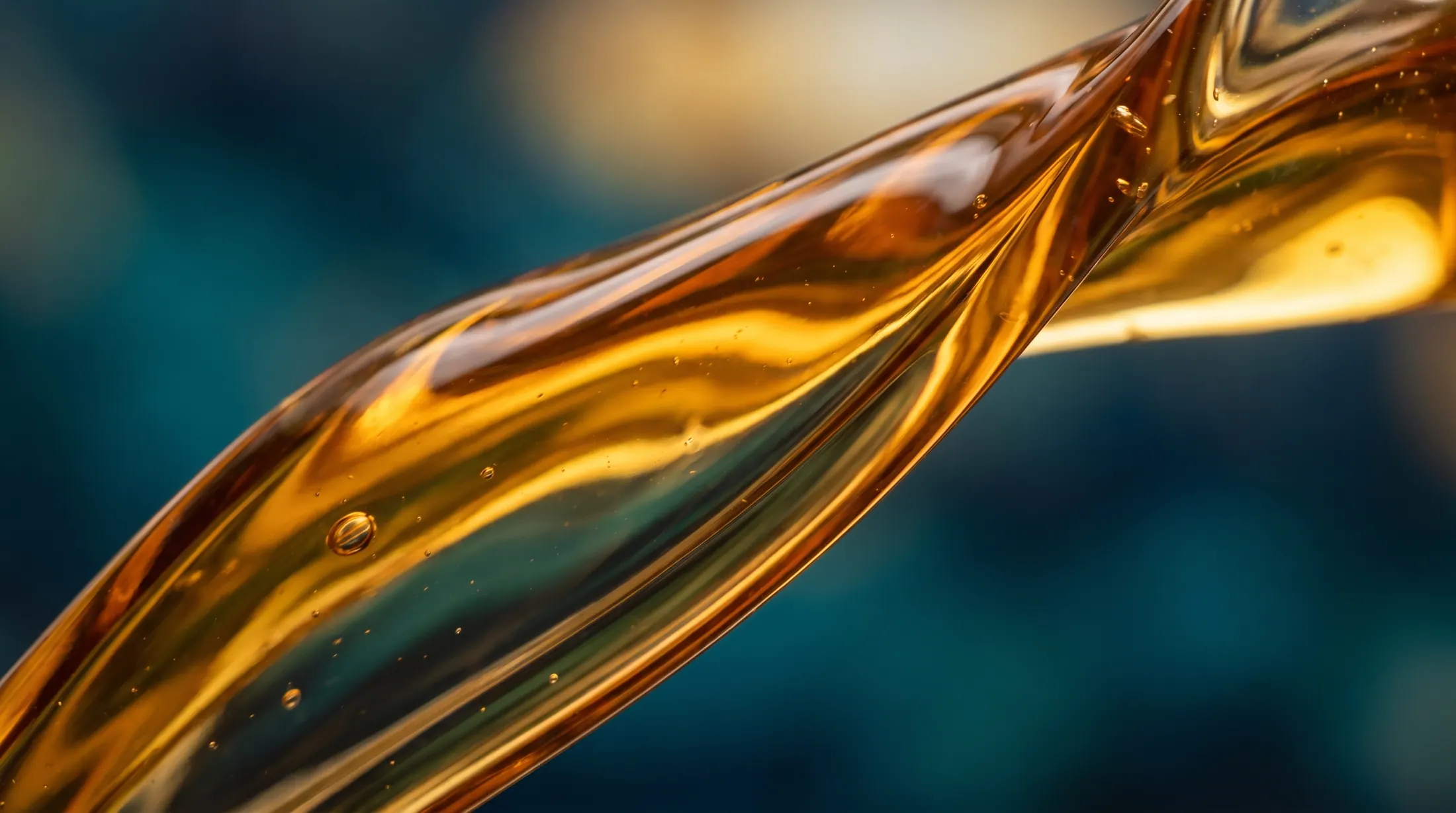 Macro shot of an amber stream of oil